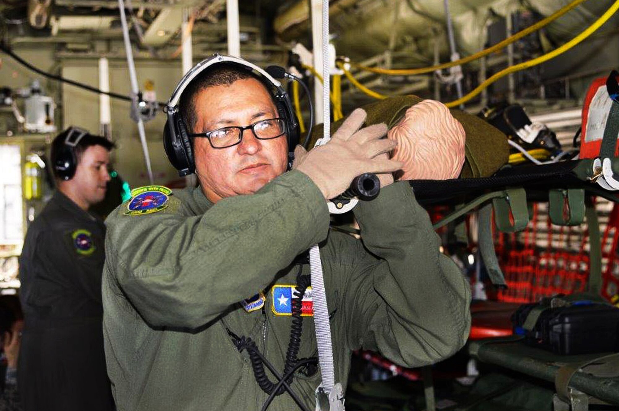 Tech. Sgt. Carlos Alaniz, 433rd Aeromedical Evacuation Squadron, flight medical technician, loads a simulated patient onto a C-130J Hercules April 29, 2017 during exercise Patriot Hook at Vandenberg Air Force Base, California. Patriot Hook is an annual joint-service exercise coordinated by the Air Force Reserve, designed to integrate the military and first responders of federal, state and local agencies by providing training to mobilize quickly and deploying in military aircraft in the event of a regional emergency or natural disaster.  (U.S. Air Force photo by Minnie Jones