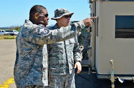 Senior Master Sgt. Reggie Daniels, air transportation superintendent, left, with Major Robert Acosta, 433rd Contingency Response Flight, and Contingency Response Element commander, April 29, 2017 discuss airfield movement during Exercise Patriot Hook at Vandenberg Air Force Base, California. Patriot Hook is an annual joint-service exercise coordinated by the Air Force Reserve, designed to integrate the military and first responders of federal, state and local agencies by providing training to mobilize quickly and deploying in military aircraft in the event of a regional emergency or natural disaster.  (U.S. Air Force photo by Minnie Jones)