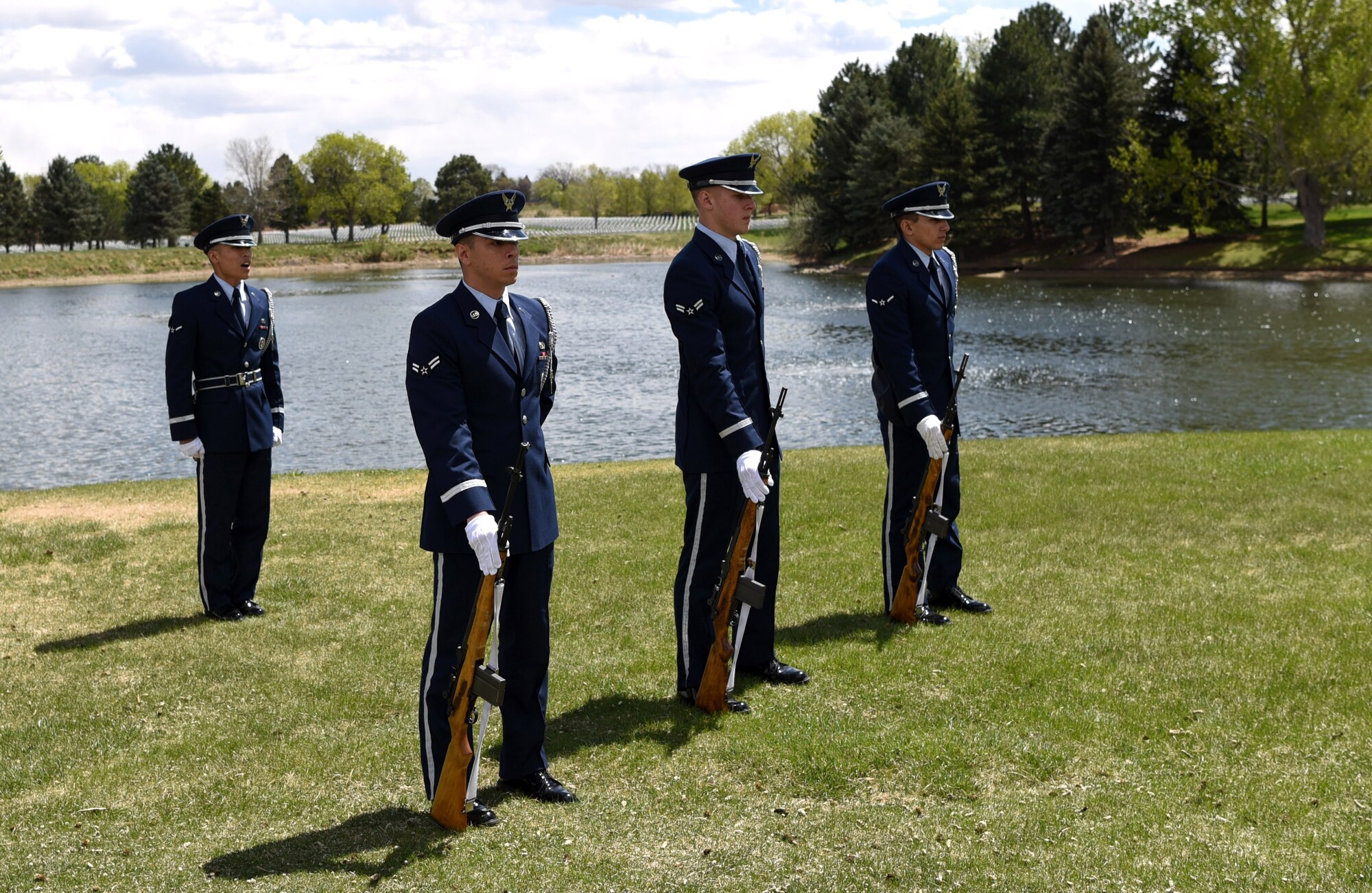 Airman Kyle Do, Mile High Honor Guard ceremonial guardsman, takes command of the firing detail during a military funeral honor, Apr. 28, 2017, at Fort Logan National Cemetery, Colo. The three member detail, carrying M-14 rifles, provided a three volley solute in honor of the deceased. Afterward, three fired rounds were presented to the next of kin. (U.S. Air Force photo by Airman 1st Class Holden S. Faul/ released)