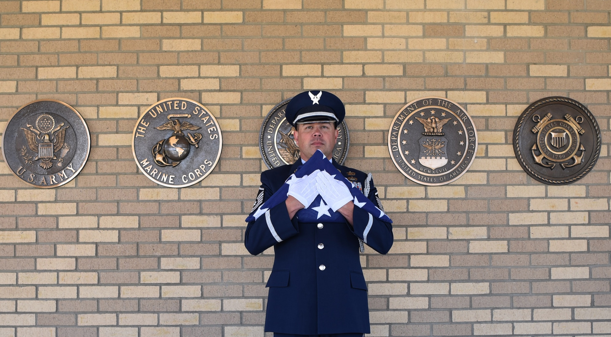 Master Sgt. Wolfram Stumpf, Mile High Honor Guard flight chief, stands with a tri-fold flag moments before presenting it to the spouse of deceased veteran, Apr. 28, 2017, at Fort Logan National Cemetery, Colo. Stumpf has been titled the 2016 Air Force Space Command Honor Guard member of the year, and is now up for the award at the Air Force level. (U.S. Air Force photo by Airman 1st Class Holden S. Faul/ released)