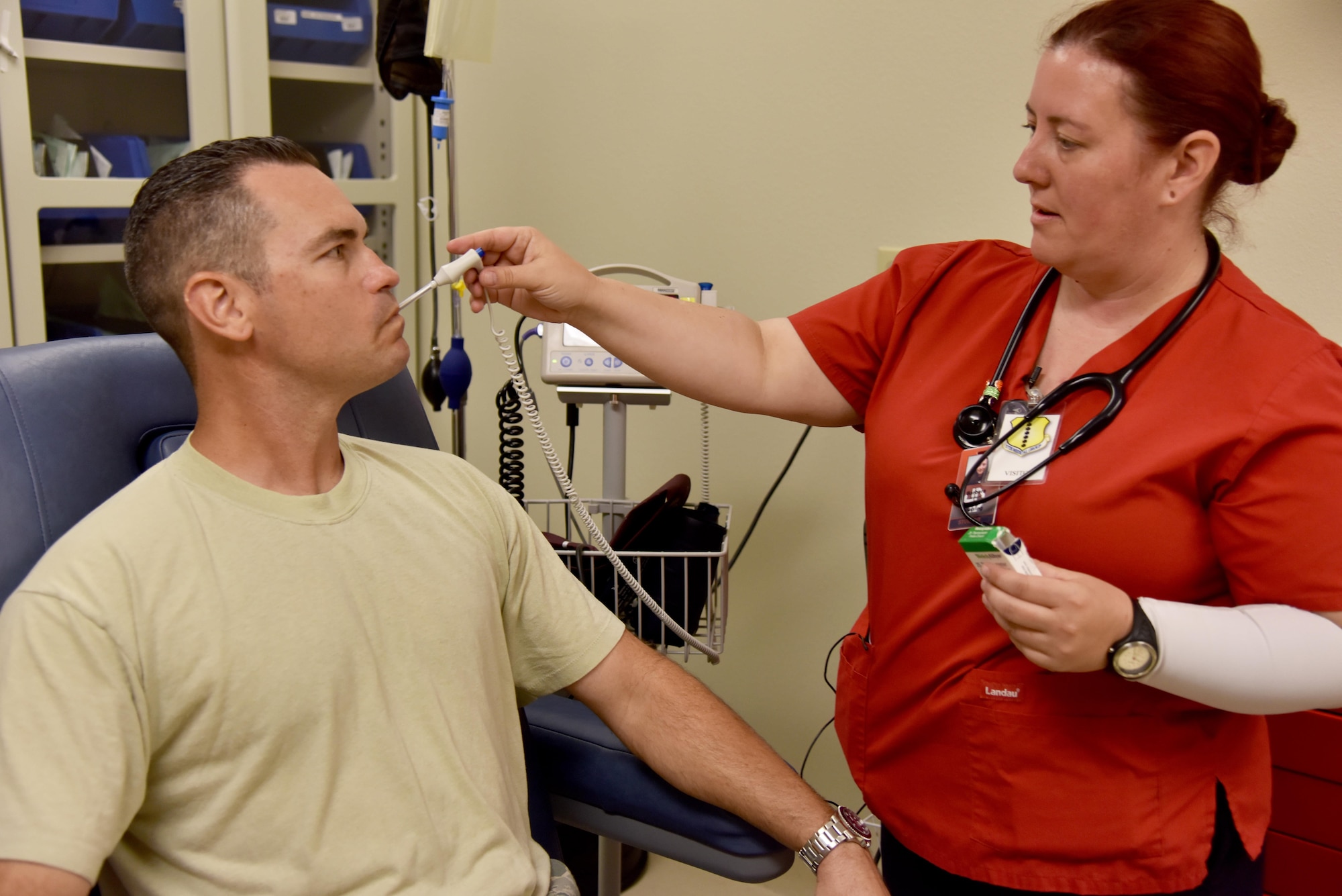 Barbara Jermyn, Howard College nursing student, practices taking a temperature on Master Sgt. John Gregg, 17th Medical Operations Squadron superintendent, at the Ross Clinic on Goodfellow Air Force Base, Texas, May 2, 2017. Jermyn and other Howard College nursing students get a chance to come to base clinic to learn from Goodfellow doctors and nurses. (U.S. Air Force photo by Staff Sgt. Joshua Edwards/Released)