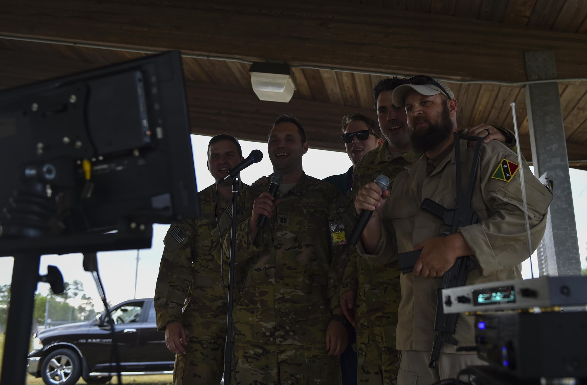 Combat aviation advisor students with the 6th Special Operations Squadron sing karaoke with “Palmetto Land” forces during Operation Raven Claw at Duke Field, Fla., April 26, 2017. Students were exposed to “Palmetto Land” culture which includes sucking the eyes out of a fish head, eating with their hands and singing karaoke. (U.S. Air Force photo by Airman 1st Class Joseph Pick)