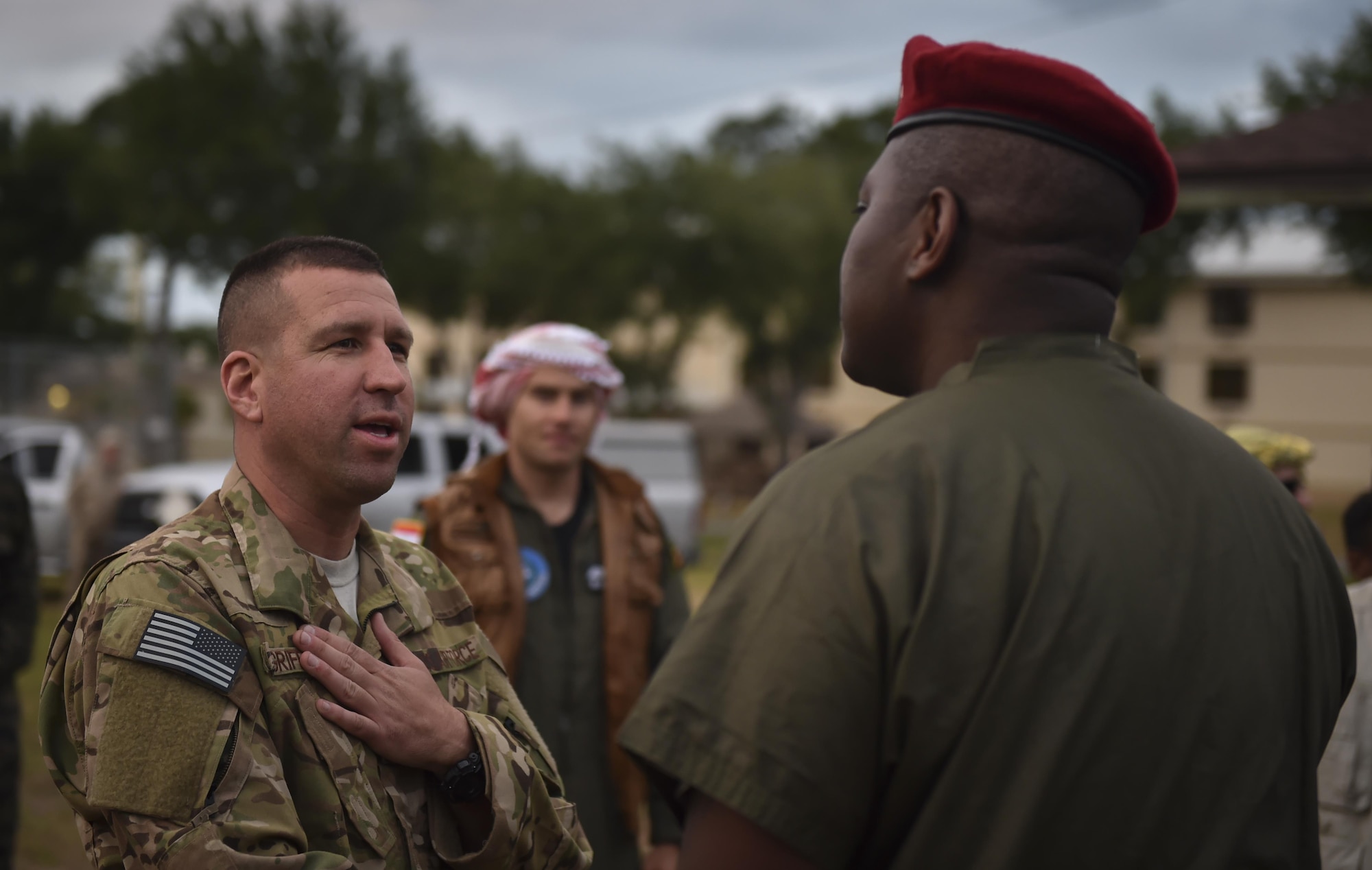 Lt. Col. Benjamin Griffith, a combat aviation advisor student with the 6th Special Operations Squadron, greets the commander of the “Palmetto Land” forces during Operation Raven Claw at Duke Field, Fla., April 26, 2017. Students were exposed to “Palmetto Land” culture which includes sucking the eyes out of a fish head, eating with their hands and singing karaoke. (U.S. Air Force photo by Airman 1st Class Joseph Pick)