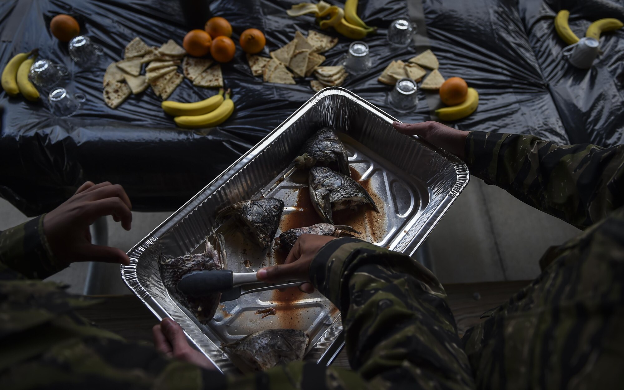 “Palmetto Land” soldiers serve fish heads to 6th Special Operations Squadron combat aviation advisor students during Operation Raven Claw at Duke Field, Fla., April 26, 2017. “Palmetto Land” is a simulated indigenous country where students were tasked to train and assist the "Palmetto Land" forces in enhancing the tactical employment of its aircraft and soldiers. (U.S. Air Force photo by Airman 1st Class Joseph Pick)