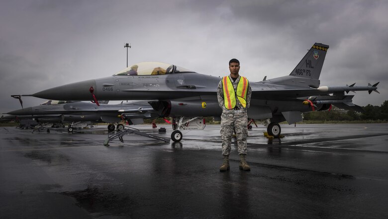 Airman 1st Class Joe Pearson, a crew chief with the 388th Fighter Wing from Hill Air Force Base, Utah, stands on the flight line in front of his F-16 Fighting Falcon, April 28, 2017, at Albacete Air Base, Spain. The active duty 388th and Reserve 419th Fighter Wings are in Spain training with NATO allies. (U.S. Air Force photo by Senior Airman Justin Fuchs)