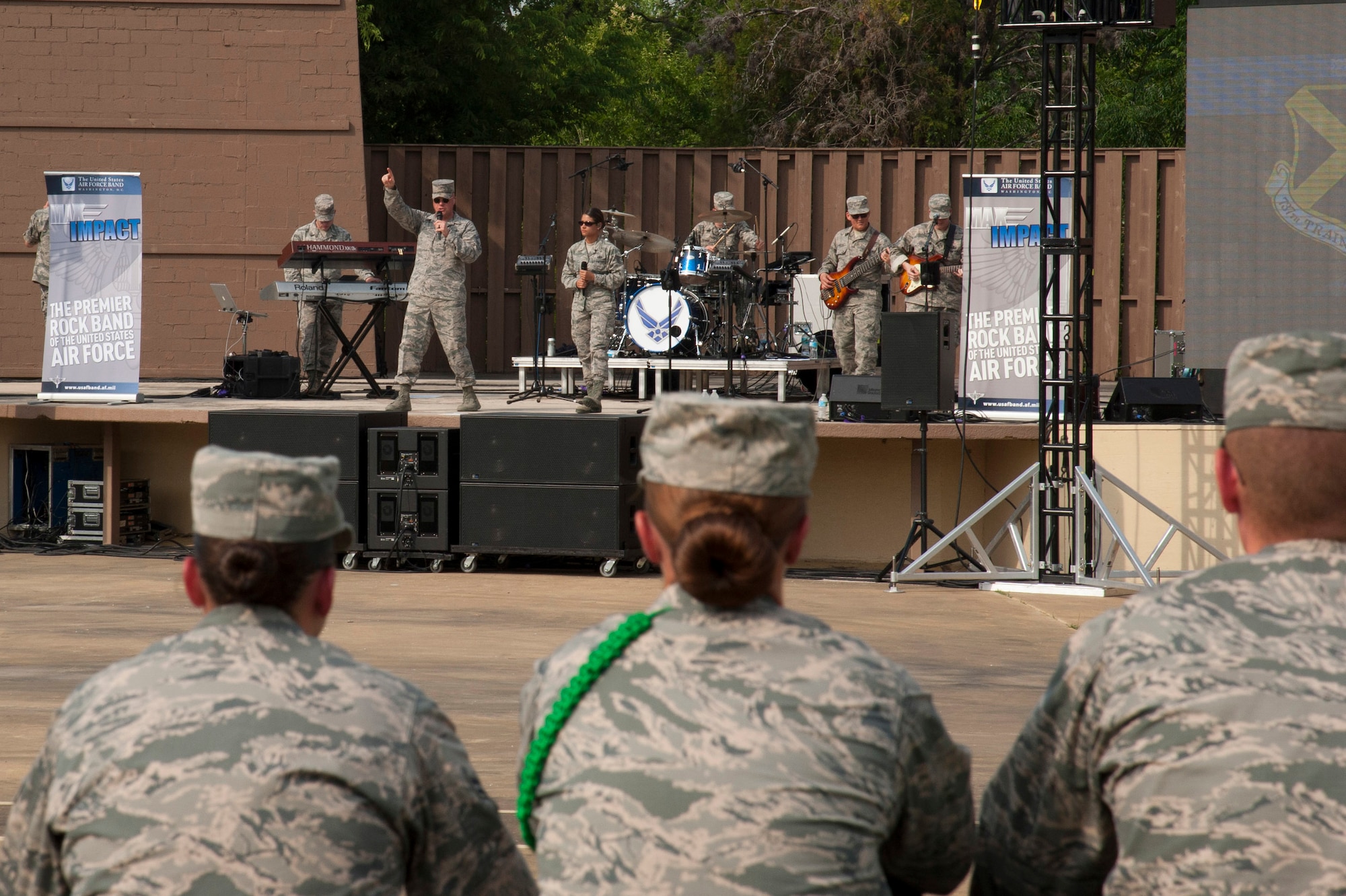 Senior Master Sgt. Ryan L. Carson, Superintendent and a vocalist, points into the crowd during a performance at the Air Force Basic Military Training Cadre's annual BBQ. The United States Air Force Band’s premier rock band, Max Impact and their debut of a song and video written especially for the 37th Training Wing Basic Military Training Cadre and support staffs. This was written as a recognition and thank you for their service and mission to, “Transform civilians into motivated, disciplined warrior Airmen with the foundation to serve in the world’s greatest Air Force.” The debut took place at Joint Base San Antonio – Lackland, Saturday April 29, 2017. (U.S. Air Force photo by Staff Sgt. Daniel Owen)