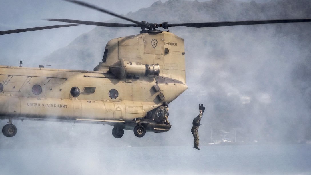 A Marine jumps out of a CH-47 Chinook during helocasting training operations as part of a reconnaissance team leader course at Marine Corps Base Hawaii, April 24, 2017. The course emphasized planning, briefing and leading teams in patrolling, ground reconnaissance and amphibious operations. Marine Corps photo by Gunnery Sgt. Ezekiel R. Kitandwe