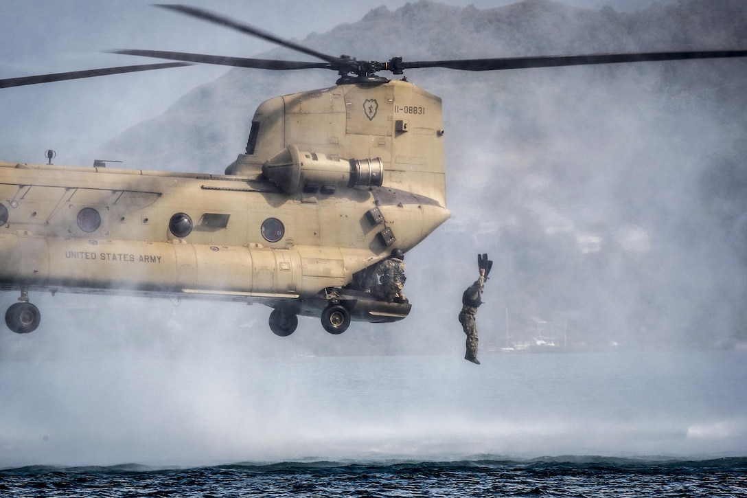 A Marine jumps out of a CH-47 Chinook during helocasting training operations as part of a reconnaissance team leader course at Marine Corps Base Hawaii, April 24, 2017. The course emphasized planning, briefing and leading teams in patrolling, ground reconnaissance and amphibious operations. Marine Corps photo by Gunnery Sgt. Ezekiel R. Kitandwe