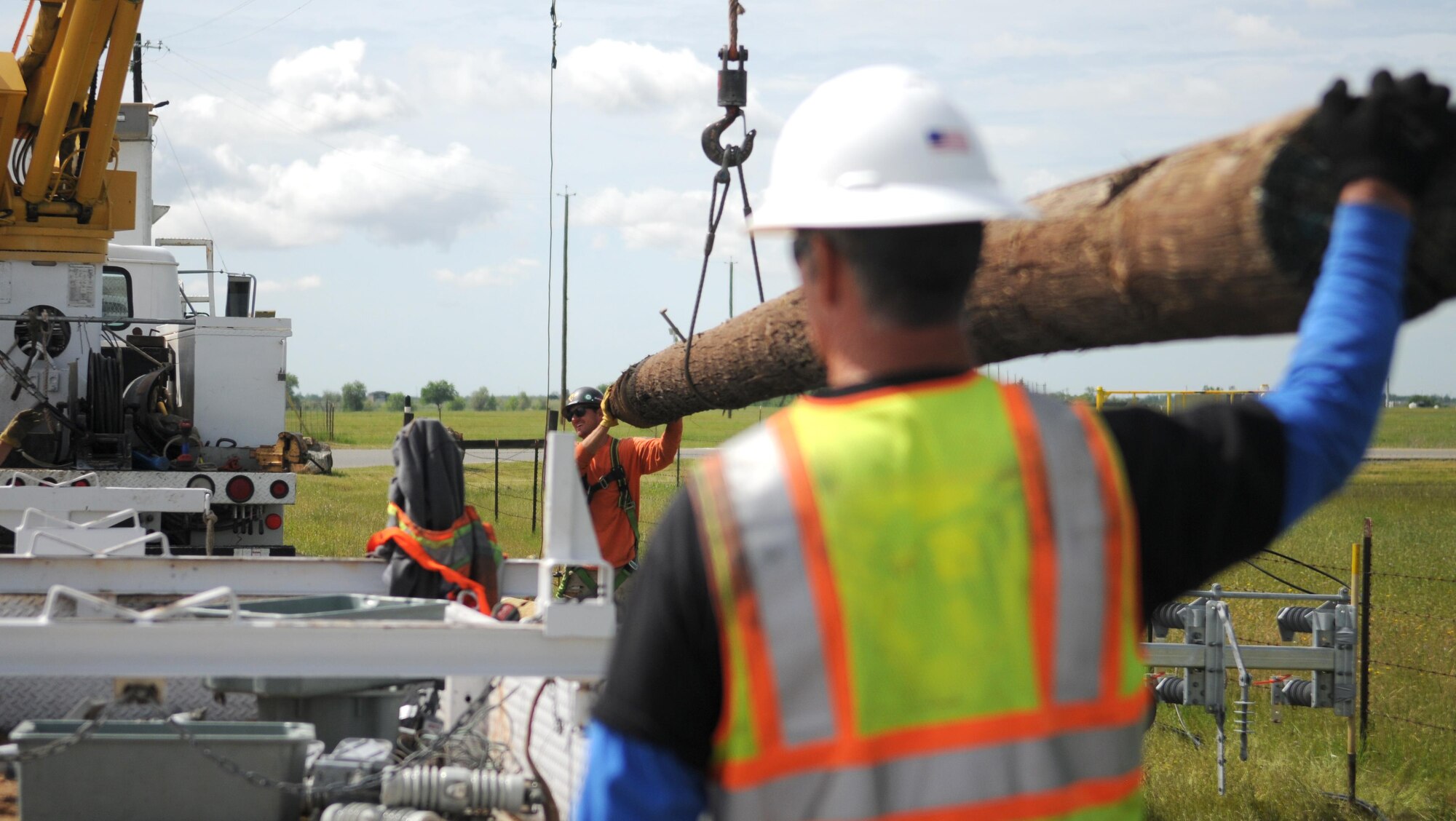 Construction workers load a power pole onto a truck to make room for its replacement at Beale Air Force Base, Calif. April 24, 2017. The new poles will be able to supply Beale with its increased energy demands in addition to weathering storms more reliably.