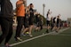 Participants in the Warrior Run fitness program perform jumping-jacks May 1, 2017, at Yokota Air Base, Japan. The Warrior Run currently has about 115 participants during the morning session and about 30 participants during the afternoon session. (U.S. Air Force photo by Airman 1st Class Donald Hudson)