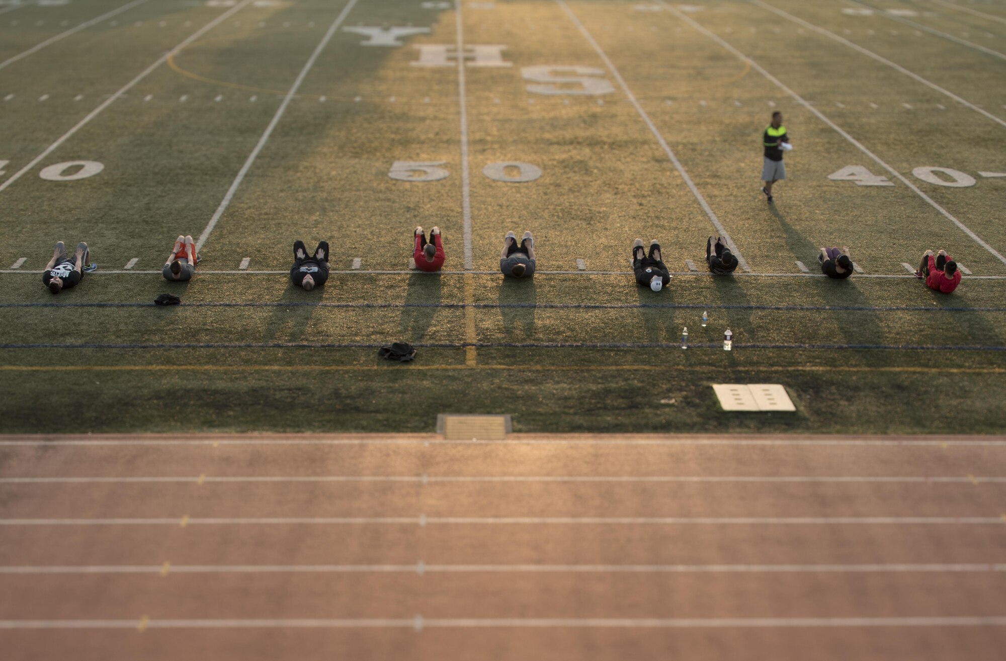 Participants in the Warrior Run fitness program perform crunches May 1, 2017, at Yokota Air Base, Japan. The last Warrior Run yielded on average a 2.5 inch waistline reduction, 11 more pushups, 8 more sit-ups and a 2 minute decrease on the 1.5 mile run. (U.S. Air Force photo by Airman 1st Class Donald Hudson)