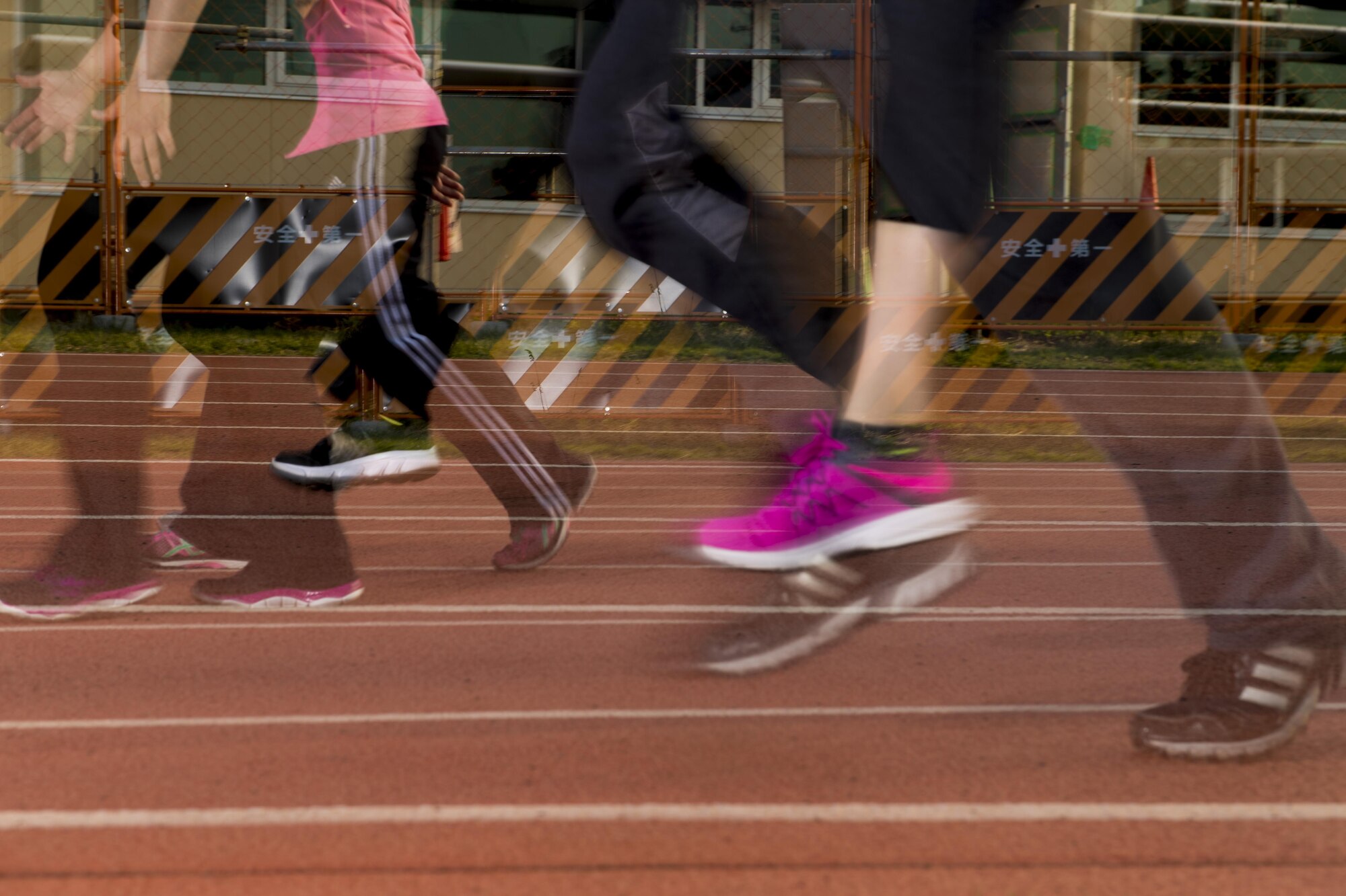 Participants of the Warrior Run fitness program run and walk on track May 1, 2017, at Yokota Air Base, Japan. The Warrior Run was started to specifically target and improve Air Force PT test scores, but has now adopted a broader focus of building a strong base community by developing healthy habits. (U.S. Air Force photo by Airman 1st Class Donald Hudson)