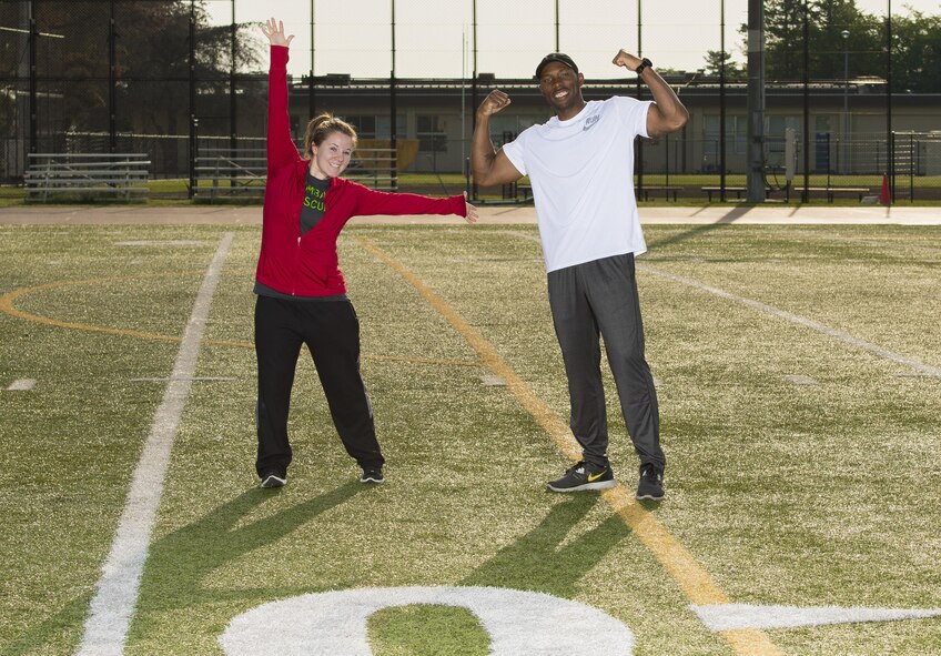 Warrior Run fitness program coaches Staff Sgt. Sydney J. Vidaurri, 374th Medical Group physical therapist and Brandon Waller, 374th Aerospace Medicine Squadron Health Promotion Flight director, pose for photo May 1, 2017, at Yokota Air Base, Japan. Each Warrior Run exercise has a hand full of coaches who are there to motivate and help people who may be having trouble with how they perform their exercises. (U.S. Air Force photo by Airman 1st Class Donald Hudson)