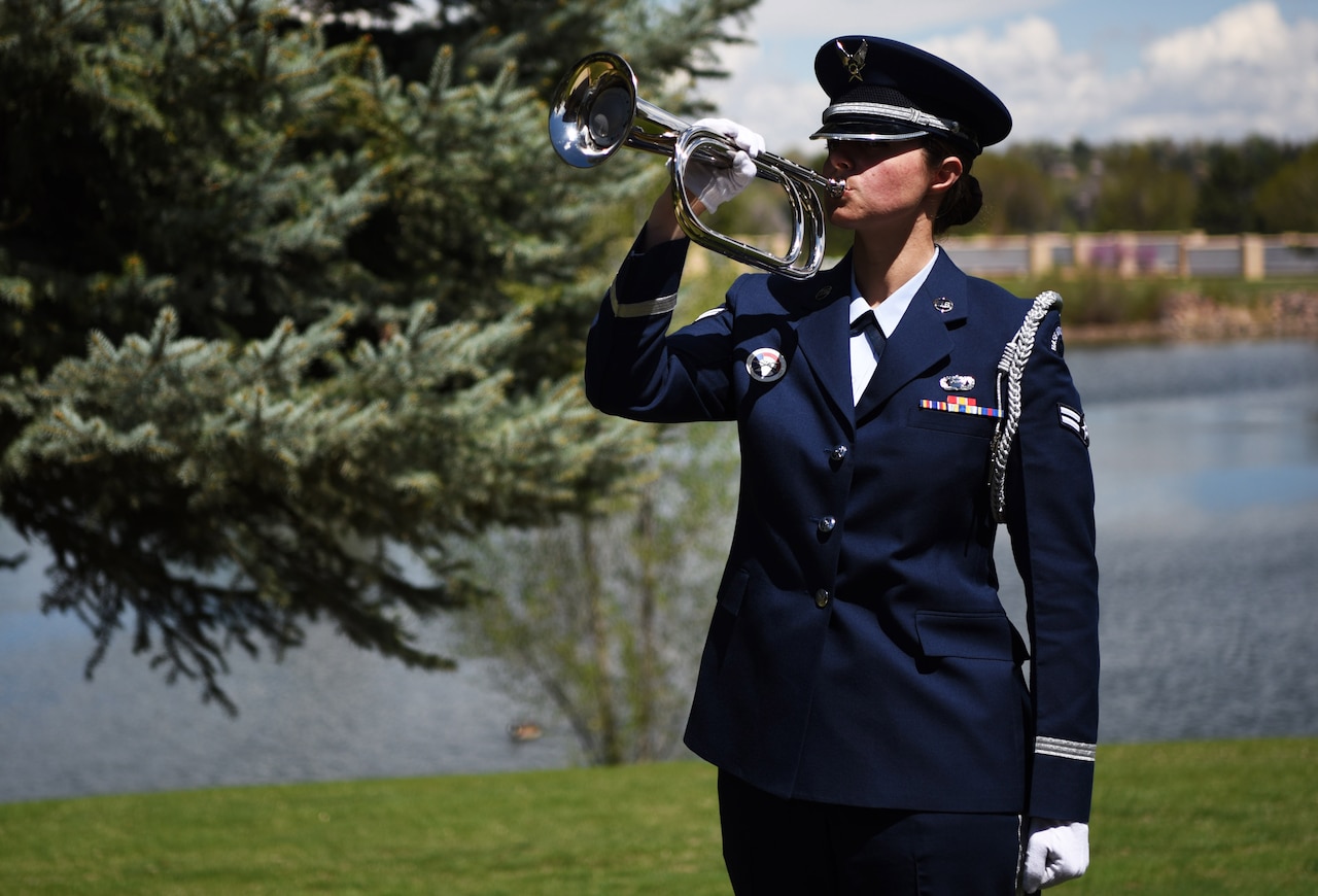 Airman 1st Class Sarah Angier, Mile High Honor Guard ceremonial guardsman, holds the bugle during the playing of Taps, Apr. 28, 2017, at Fort Logan National Cemetery, Colo. Since the Civil War, Taps has been offered as the final salute to America’s fallen.  (U.S. Air Force photo by Airman 1st Class Holden S. Faul/ released)