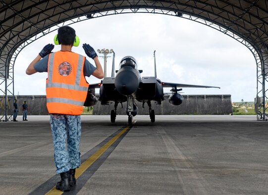 A Republic of Singapore Air Force (RSAF) service member marshalls an F-15SG April 10, 2017, at Andersen Air Force Base, Guam. The RSAF is deployed here to conduct bilateral training for aircrew and maintenance personnel to sharpen their skills and strengthen ties with partners in the Pacific. (U.S. Air Force photo/Airman 1st Class Gerald R. Willis)