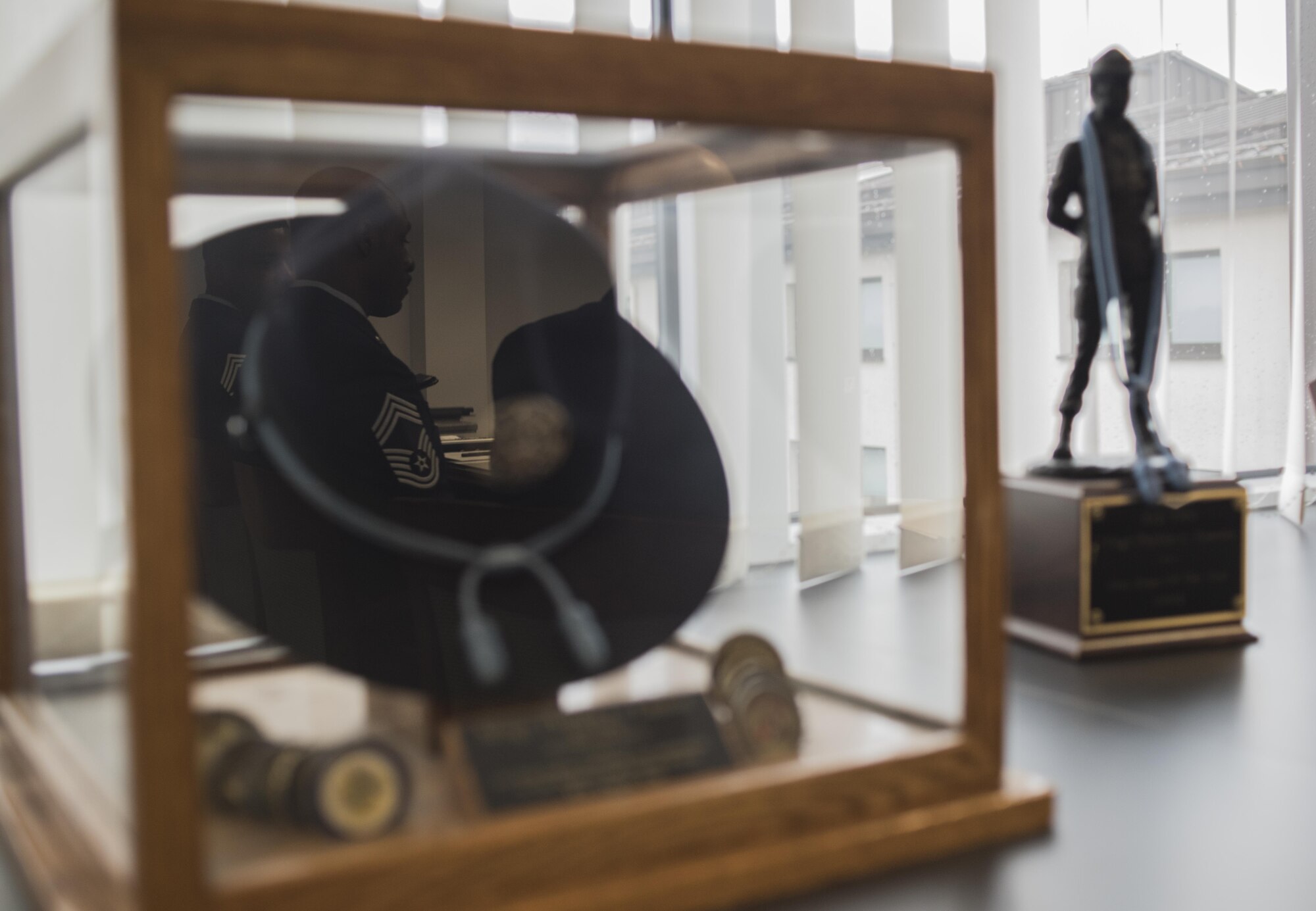 Chief Master Sergeant Phillip L. Easton, U.S. Air Forces in Europe and Air Forces Africa command chief master sergeant, displays various memorabilia in his office attesting to his experiences over more than 25 years of service in the United States Air Force, March 9, 2017, Ramtein Air Base, Germany. Aircraft maintainer, first sergeant and military training instructor are just some of the positions Easton has held. (U.S. Air Force Photo/Tech. Sgt. Micky M. Pena)