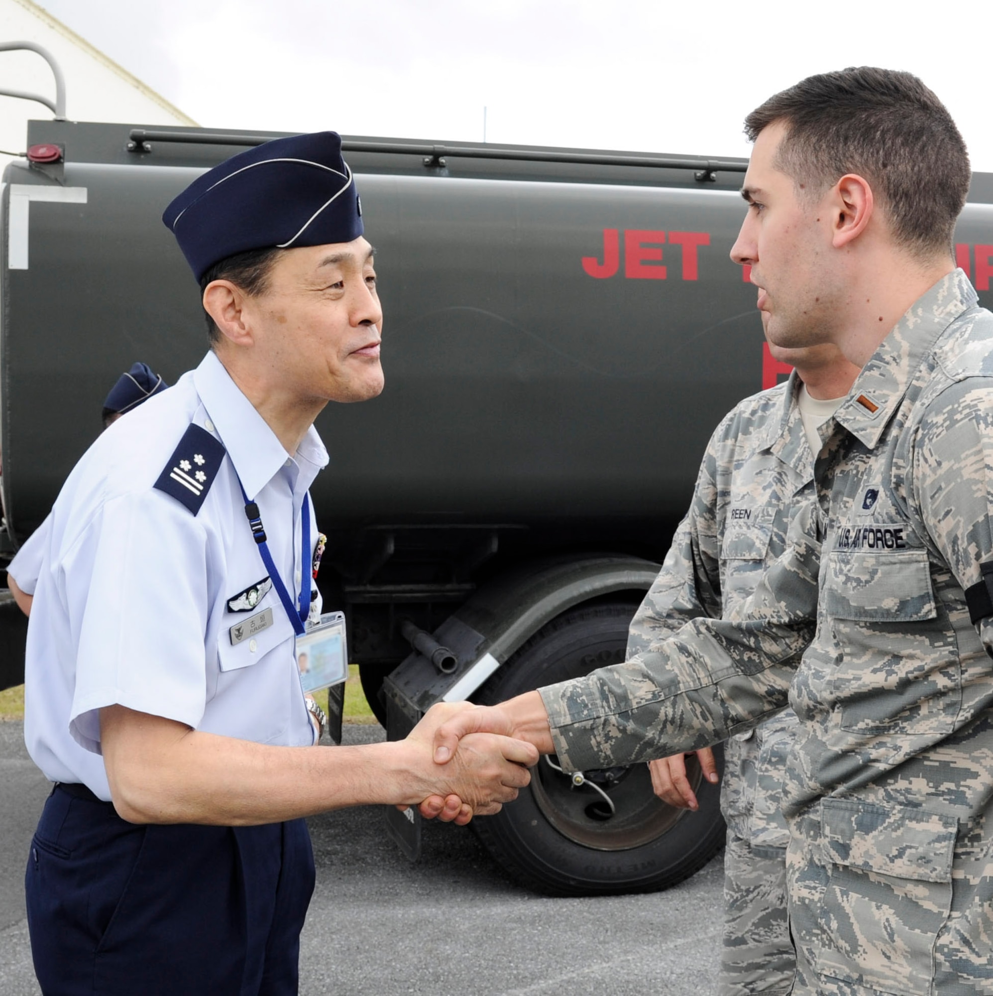 Japan Air Self-Defense Force Col. Riichi Furugaki, JASDF Air Staff College director of education department, greets U.S. Air Force 2nd Lt. William Holmquist, 18th Logistics Readiness Squadron fuels operations officer, April 27, 2017, at Kadena Air Base, Japan. Leaders from the JASDF Air Staff College visited the 18th LRS petroleum, oils and lubricants flight to learn about the systems Kadena AB uses. (U.S. Air Force photo by Senior Airman Lynette M. Rolen)