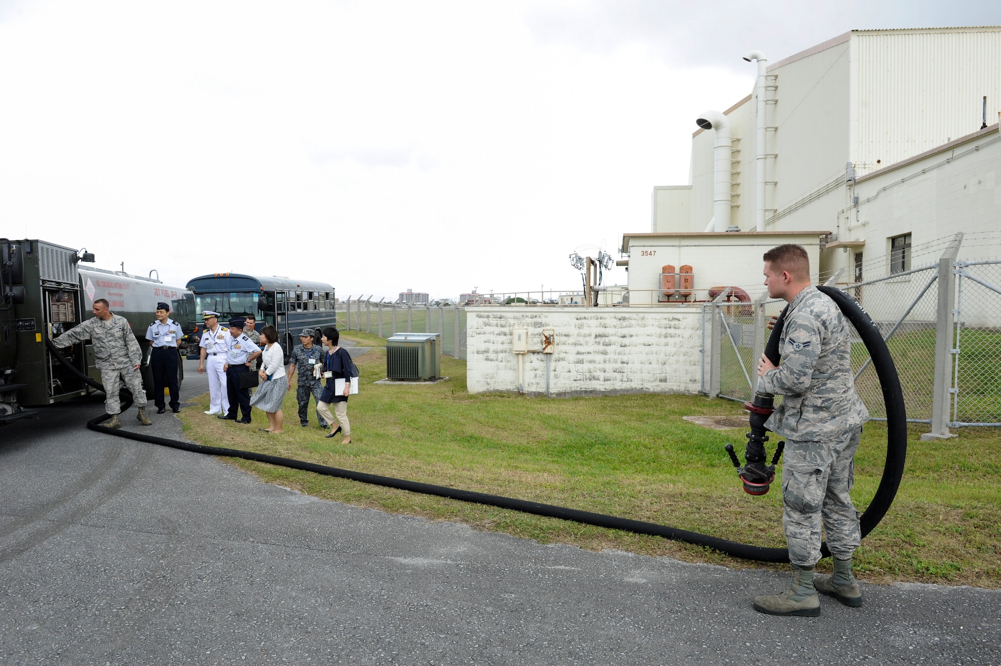 U.S. Air Force Airman 1st Class Anthony Stark, 18th Logistics Readiness Squadron fuels distribution operator, demonstrates the reach of a hose on an R-11 refueling truck April 27, 2017, at Kadena Air Base, Japan. The R-11 is a 6,000 gallon refueling unit capable of issuing 600 gallons of jet fuel per minute to aircraft. (U.S. Air Force photo by Senior Airman Lynette M. Rolen)