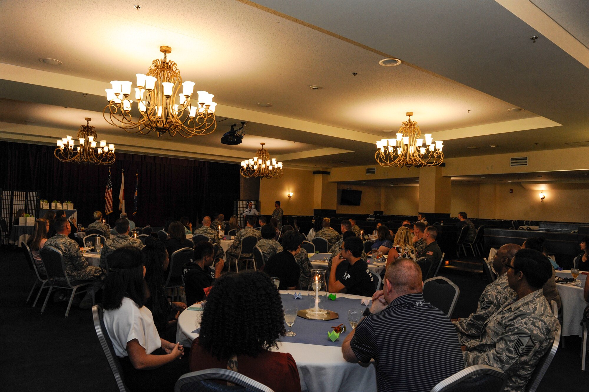 Volunteers from Kadena Air Base listen to U.S. Air Force Capt. James Taylor, 18th Wing chaplain, as he speaks during the 18th Wing Annual Volunteer Recognition ceremony April 28, 2017, at Kadena Air Base, Japan. More than 100 volunteers attended the ceremony, celebrating their contributions to Kadena and the local community. (U.S. Air Force photo by Senior Airman Lynette M. Rolen)