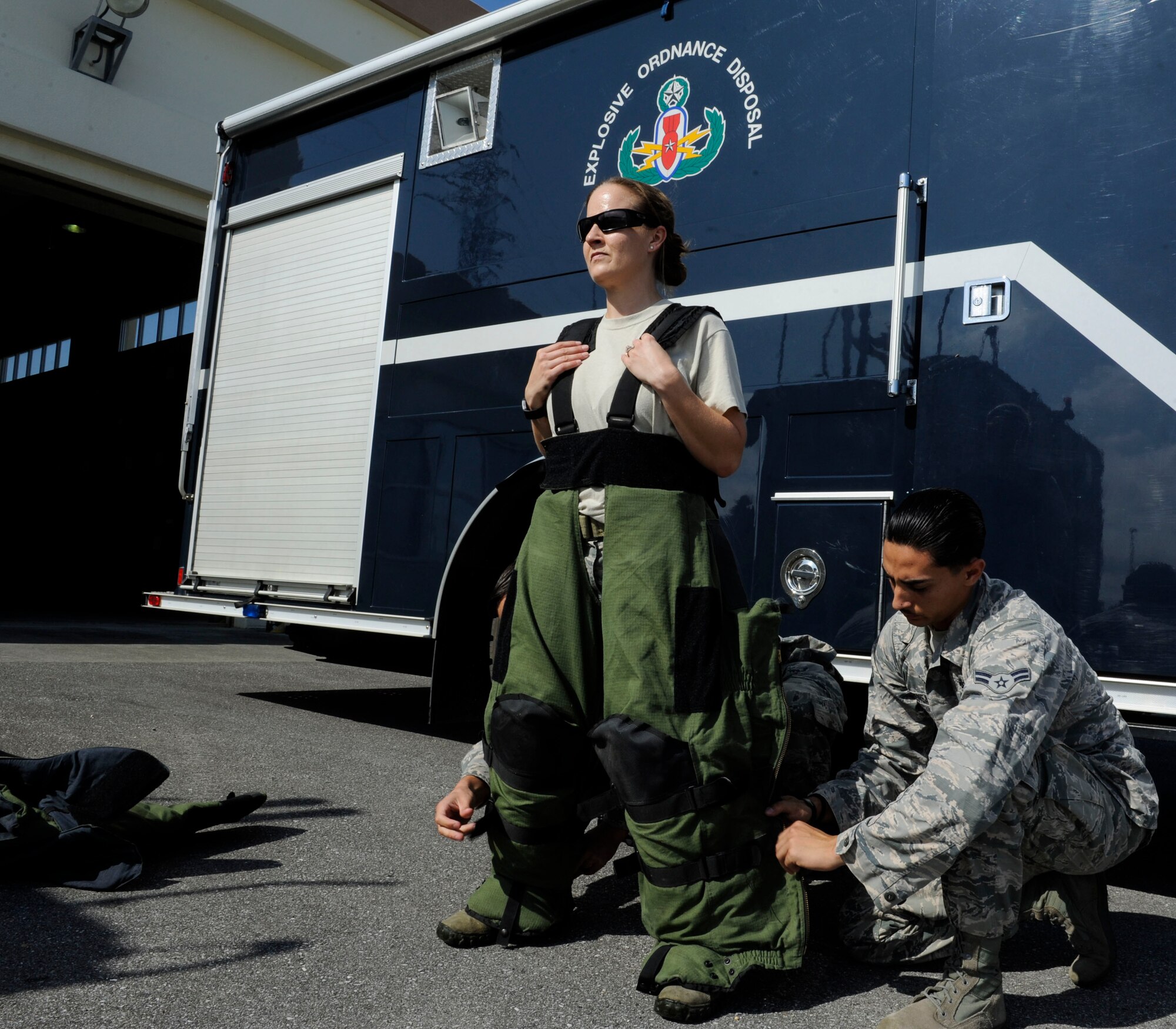 U.S. Air Force Tech. Sgt. Rebecca Kimberling, 18th Civil Engineer Squadron Explosive Ordnance Disposal supply NCO in charge, is assisted into an EOD bomb suit by Airmen 1st Class Anthony Beschi and Quentin Deneau, 18th CES EOD apprentices, May 4, 2017, at Kadena Air Base, Japan. Kimberling frequently trains and mentors EOD Airmen, encouraging professional excellence. (U.S. Air Force photo by Senior Airman Lynette M. Rolen)