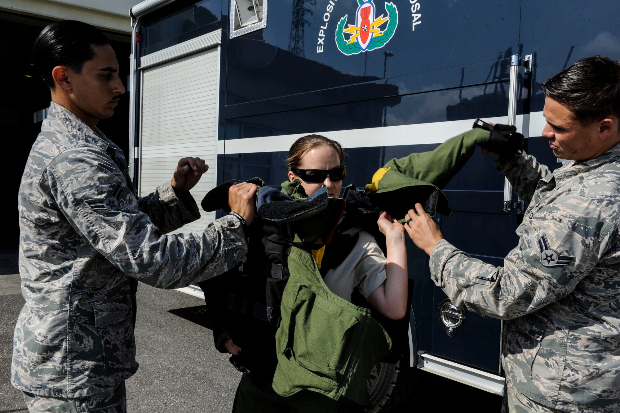 U.S. Air Force Tech. Sgt. Rebecca Kimberling, 18th Civil Engineer Squadron Explosive Ordnance Disposal supply NCO in charge, is assisted into an EOD bomb suit by Airmen 1st Class Anthony Beschi and Quentin Deneau, 18th CES EOD apprentices, May 4, 2017, at Kadena Air Base, Japan. Frequent training for EOD response methods is integral to maintaining proficiency and readiness for any contingency. (U.S. Air Force photo by Senior Airman Lynette M. Rolen)