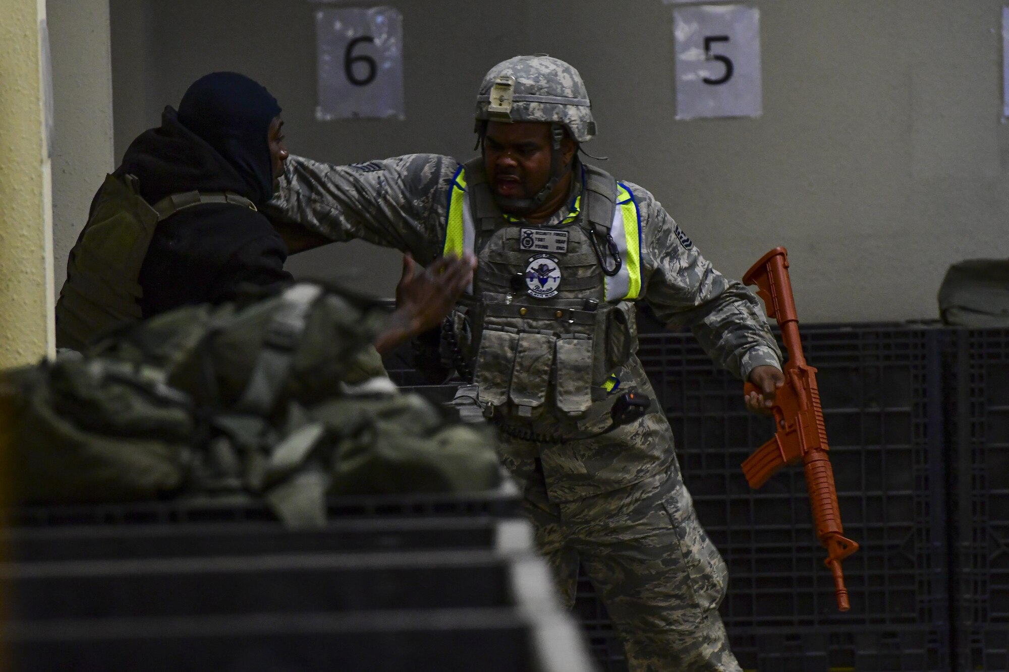 U.S. Air Force Tech. Sgt. Eric Young, 51st Security Forces Squadron flight sergeant, wrestles U.S. Air Force Tech. Sgt. Michael Denson, 51st SFS Defender, to the ground during Exercise Beverly Sentinel 17-1 at Osan Air Base, Republic of Korea, May 4, 2017. Young successfully overpowered and restrained Denson after a brief hand-to-hand fight, ending the manhunt and clearing the way for medical personnel to treat the Airmen with simulated injuries from the active shooter. (U.S. Air Force photo by Staff Sgt. Victor J. Caputo)