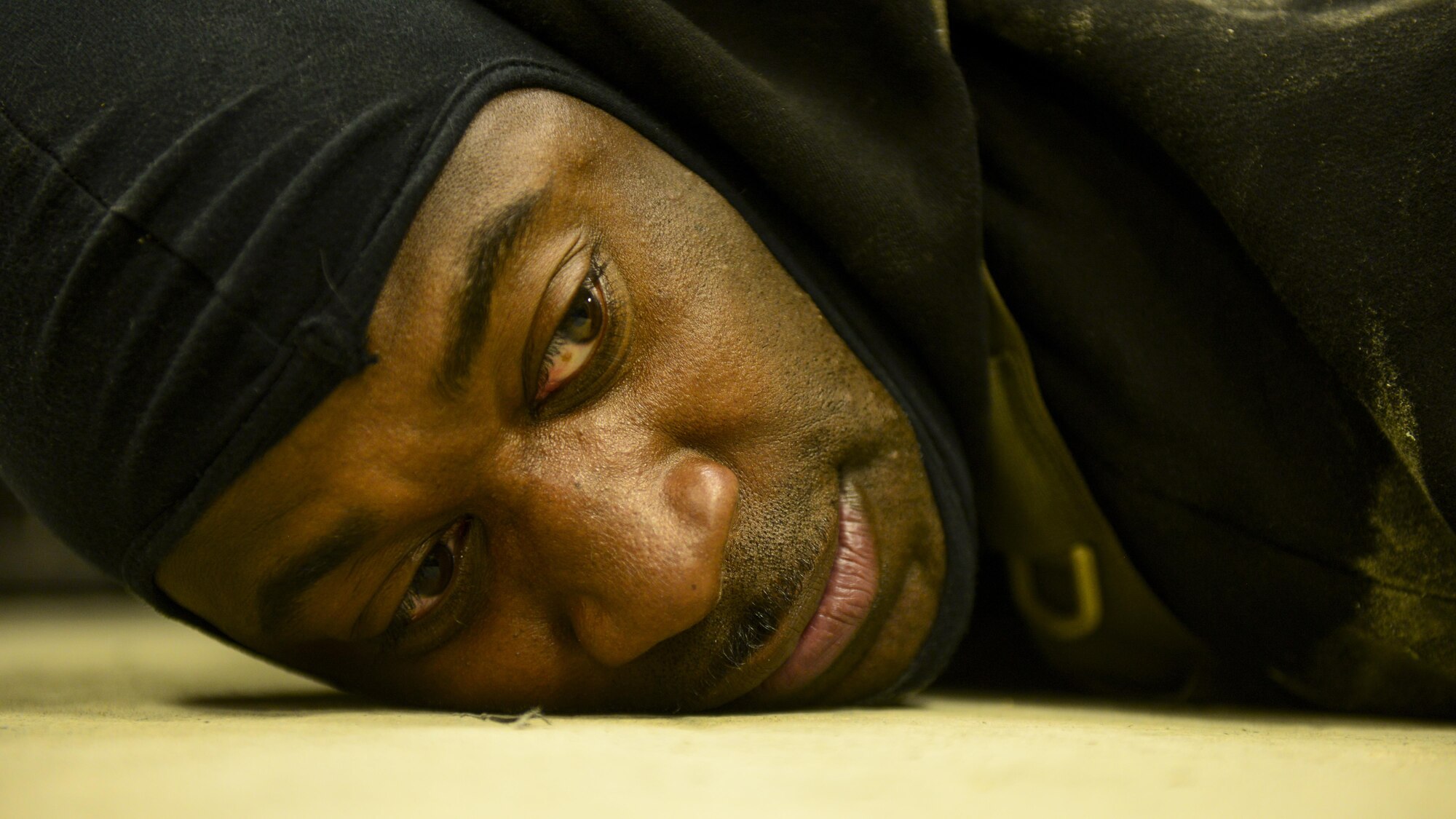U.S. Air Force Tech. Sgt. Michael Denson, 51st Security Forces Squadron Defender, lies on the ground after being apprehended during Exercise Beverly Sentinel 17-1 at Osan Air Base, Republic of Korea, May 4, 2017. Beverly Sentinel exercises test Team Osan’s ability to react to threats like active shooters, requiring agencies ranging from command post to security forces to swiftly respond to the present threat. Denson was one of two Defenders playing the role of a hostile shooter. (U.S. Air Force photo by Staff Sgt. Victor J. Caputo)