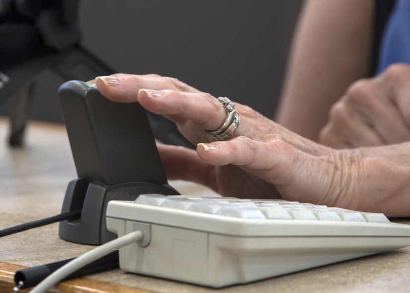 Arlene Wagner, Gold Star mother, places her finger on a scanner for a Gold Star Base Access ID card at Joint Base Andrews, Md., May 1, 2017. These cards are part of an Air Force initiative allowing Gold Star families unescorted access to Air Force installations to visit buried loved ones, attend base events, and stop by Airmen and Family Readiness Centers for support. To welcome more Gold Star families to base through this program, each member is scheduled to receive a letter signed by the Air Force installation commander closest to where they reside informing them of the Air Force-wide implementation scheduled to begin May 15, 2017. The Air Force initiative refers to parents, grandparents, siblings and adult children of Airmen killed in action, international terrorist attack against the U.S. or military operations while serving outside the U.S. as part of a peacekeeping force. (U.S. Air Force photo by Senior Airman Jordyn Fetter)