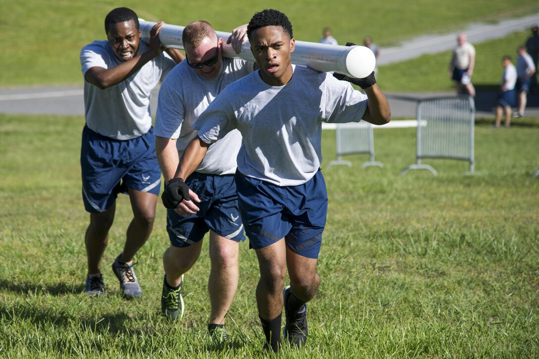 Staff Sgt. Courtney Murphy, Staff Sgt. Brian Healey, and Senior Airman Joshua Williams, all 25th Aerial Port Squadron air transportation specialists, assault the hill at the finish of the fit to fight course during the Air Force Reserve Command Port Dawg Challenge at Dobbins Air Reserve Base, Ga., April 26, 2017.  The AFRC Port Dawg Challenge was created to enhance and maintain the camaraderie, esprit de corps and prestige of aerial port Airmen while promoting professionalism, leadership, training and communication between Port Dawgs. (U.S. Air Force photo/1st Lt. Virginia Lang)
