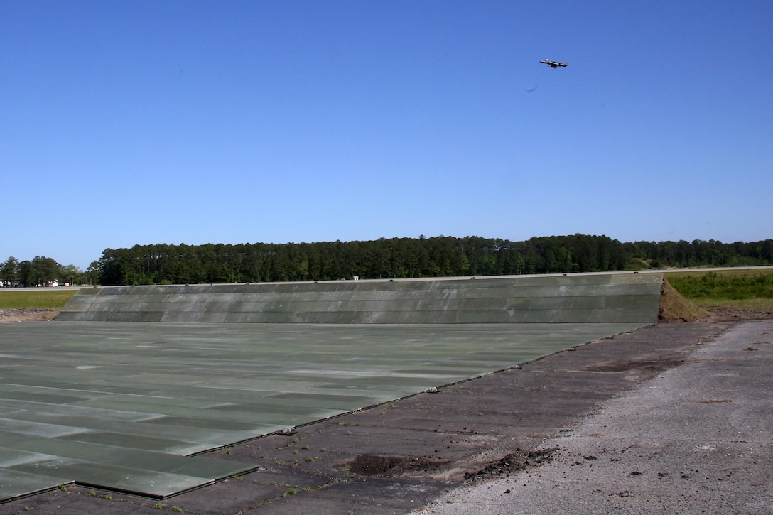 An AV-8B Harrier flies over the recently built high power run up system at Marine Corps Air Station Cherry Point, N.C., May 2, 2017. Heavy equipment operators and expeditionary airfield Marines assigned to Marine Wing Support Squadron 274, Marine Aircraft Group 14, 2nd Marine Aircraft Wing worked to construct the system together. The project was conducted by 25 Marines overall and required a total of 2,000 work hours to complete. (U.S. Marine Corps photo by Cpl. Mackenzie Gibson/Released)