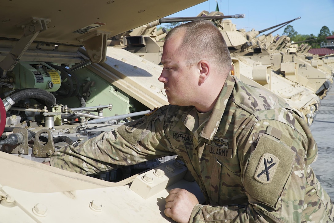 Army Staff Sgt. Jeffrey Hoffhaus, with the South Carolina National Guard's Alpha Company, 4th Combined Arms Battalion, 118th Infantry Regiment, inspects his Bradley fighting vehicle before a gunnery exercise at Fort Stewart, Ga., April 10, 2017. South Carolina Army National Guard photo by Capt. Brian Hare