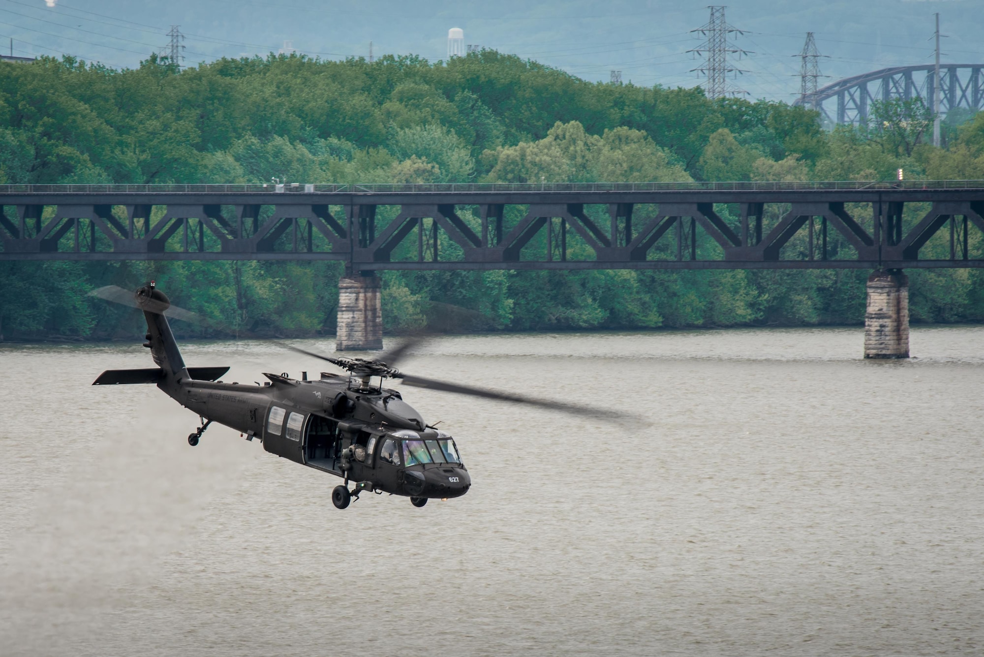 A Kentucky Army National Guard UH-60 Blackhawk helicopter flies over the Ohio River after deploying Kentucky Air National Guardsmen into to the water to conduct a simulated rescue mission during the Thunder Over Louisville air show in Louisville, Ky., April 22, 2017. The annual show has grown to become the largest single-day event of its kind in the nation. (U.S. Air National Guard photo by Lt. Col. Dale Greer)