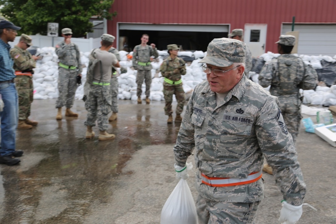 Missouri Air National Guard Senior Master Sgt. John Matthews leads from the front as he and his airmen aid in the construction of sandbag walls around local businesses in Eureka, Mo., May 2, 2017.  Matthews led 30 airmen to Eureka to support civilians and ensure their safety. Army National Guard photo by Pfc Garrett Bradley
