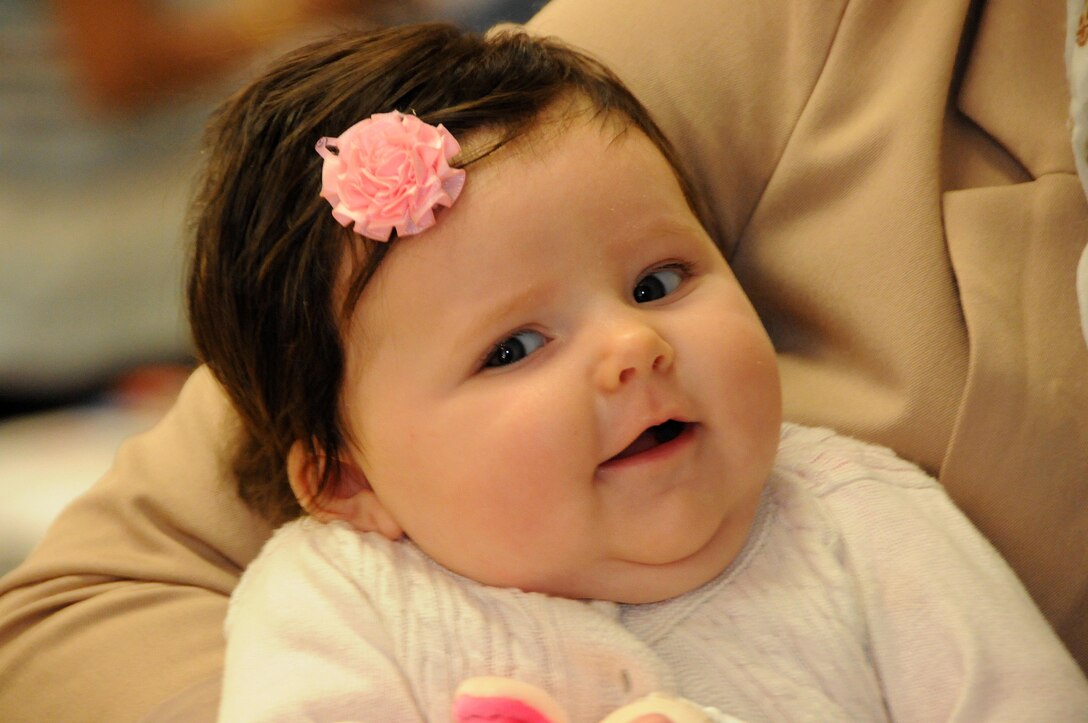 Three-month-old Nina Maire Gutowski and her mom Anita wait for the start of Star-Spangled Babies May 3 at the 99th Regional Support Command on Joint Base McGuire-Dix-Lakehurst, New Jersey.  Operation Homefront sponsored the event where roughly 70 new and expecting military mothers received a free crib from Delta Children as well as other gifts.