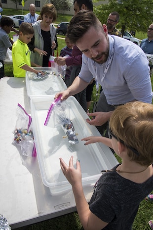 Chris Greenhough, a marine engineer with Naval Surface Warfare Center, Carderock Divisions Center for Innovation in Ship Design, teaches visiting children ship design and buoyancy principles during Carderocks event for Take Our
Daughters and Sons to Work Day in West Bethesda, Maryland, April 27, 2017. More than 200 children aged 7-18 visited Carderock to see where and how their parents use their talents as scientists, engineers, technicians and other roles in support of the Department of the Navy. (U.S. Navy photo by Dustin Q. Diaz/Released)