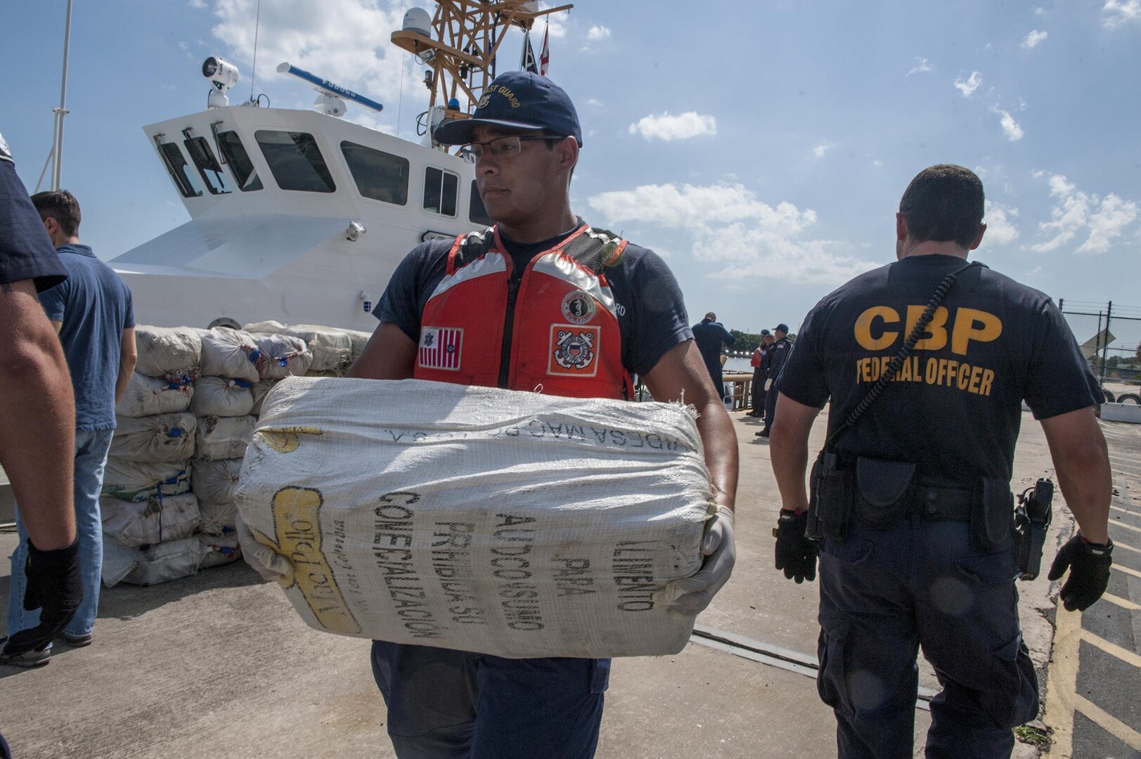A crew member from Coast Guard Cutter Tarpon, an 87-foot Coast Patrol Boat homeported in St. Petersburg, Florida, and his crew offload 1,735 kilograms of cocaine, an estimated wholesale value of $56 million, Wednesday, May 3, 2017 at Coast Guard Sector St. Petersburg, Florida. The contraband was interdicted during four separate cases supporting Operation Martillo, a joint interagency and multi-national collaborative effort among 14 Western Hemisphere and European nations to stop the flow of illicit cargo by Transnational Criminal Organizations. (U.S. Coast Guard photo by Petty Officer 1st Class Michael De Nyse)