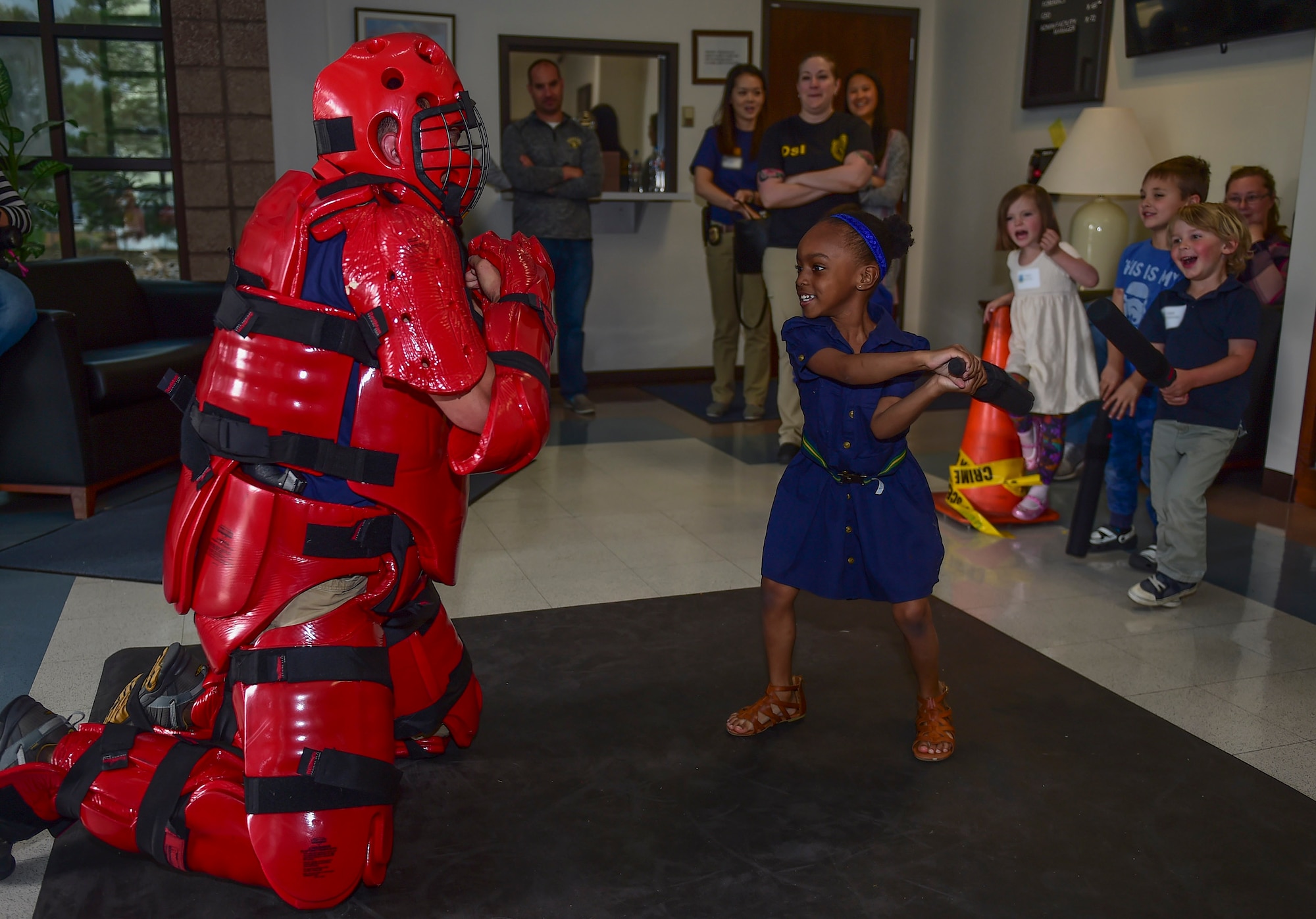 Anais, a Buckley Youth, practices arresting methods on Special Agent Jason, 12th Field Investigation Squadron on “Bring Our Daughters and Sons to Work Day” April 27, 2017, on Buckley Air Force Base, Colo. The children spent the day learning investigation skills, including forensics and arresting techniques. (U.S. Air Force photo by Airman Jacob Deatherage/Released)