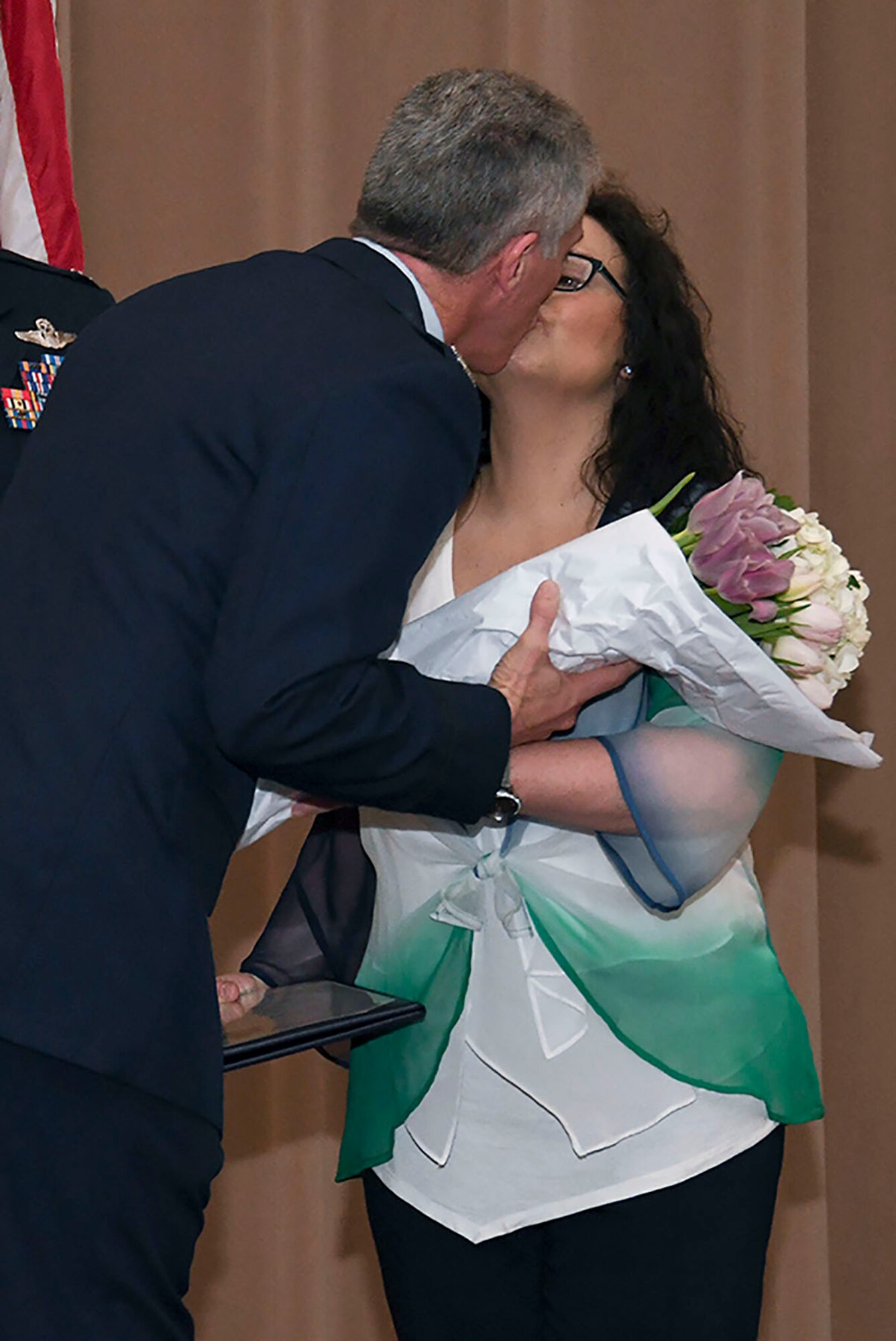 Col. James L. Morriss III, the 307th Bomb Wing vice commander, kisses his wife Melody during his retirement ceremony at Barksdale Air Force Base, La., April 29, 2017.  Morriss retired from the Air Force after 31 years of military service. (U.S. Air Force photo by Staff Sgt. Callie Ware/Released)
