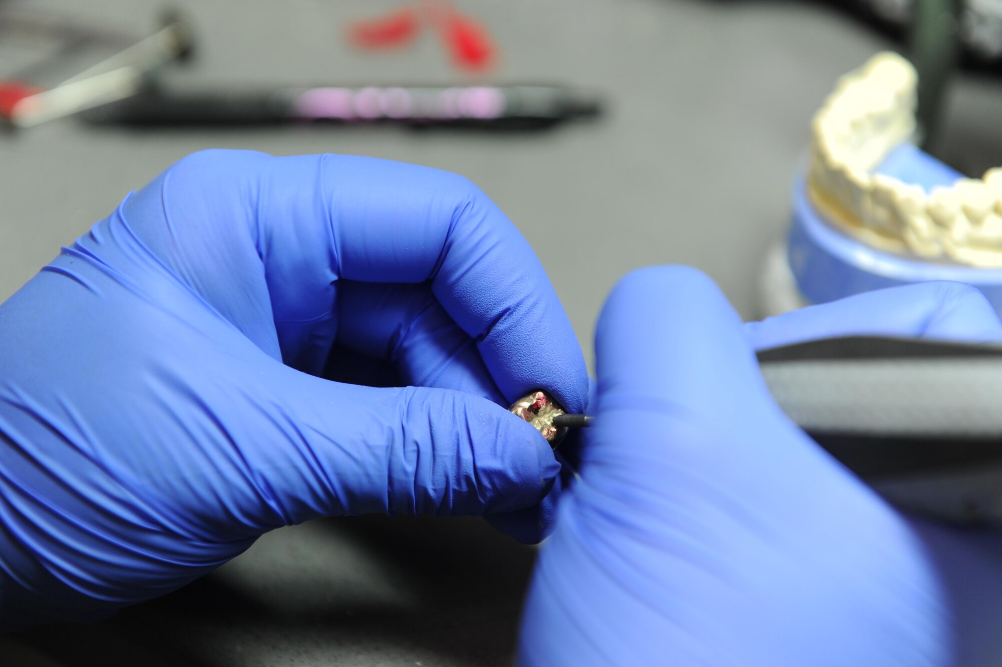 Staff Sgt. Kristina Plunkett, a dental laboratory technician with the 1st SODS polishes a finished crown at Hurlburt Field, Fla., May 2, 2017. The six-man shop completes approximately 1,000 active cases a year. (U.S. Air Force photo by Airman 1st Class Isaac O. Guest IV)
