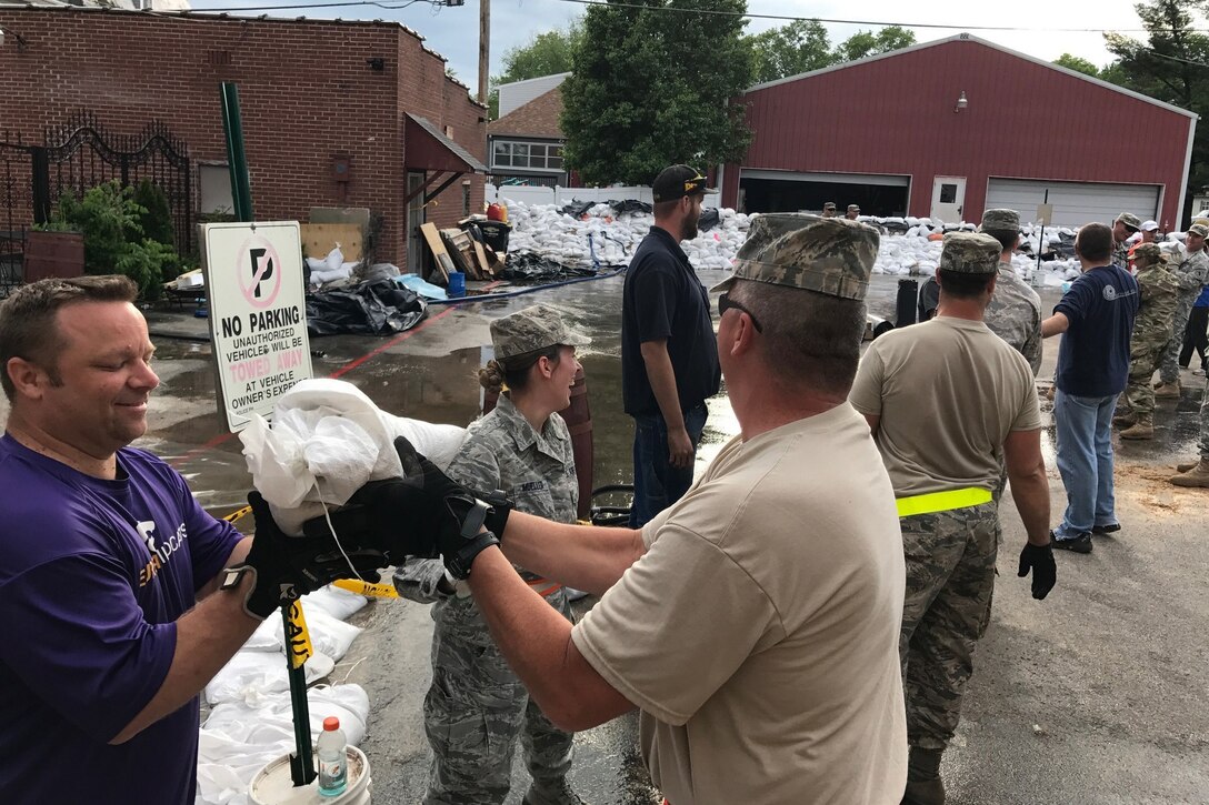 Missouri National Guard soldiers and airmen work together to place  sandbags in Eureka, Mo., May 2, 2017. More than 500 Missouri guardsmen are on duty fighting floods throughout the eastern part of the state. Army photo by Staff Sgt. Christopher Robertson