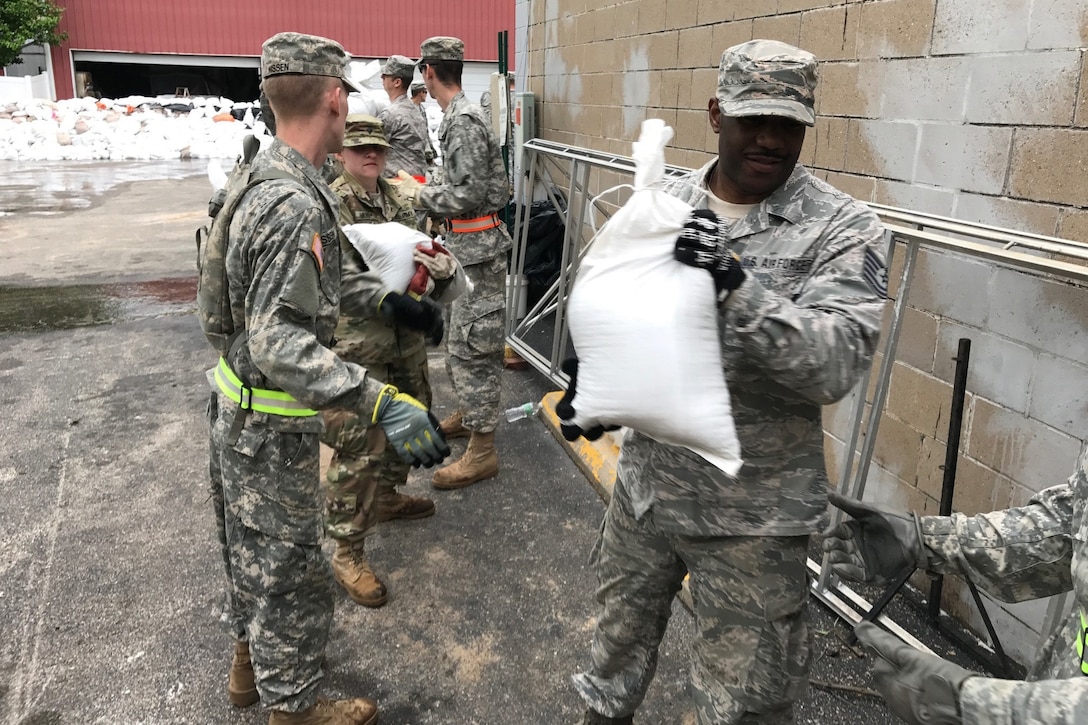 Missouri National Guard soldiers and airmen work together to place sandbags in Eureka, Mo., May 2, 2017. More than 500 Missouri guardsmen are on duty fighting floods throughout the eastern part of the state. Army photo by Staff Sgt. Christopher Robertson