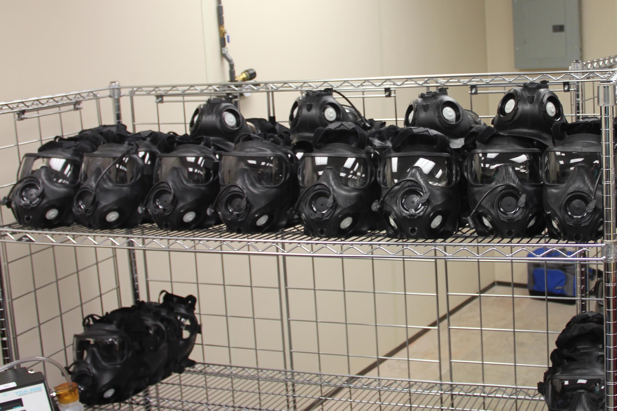 A rack of clean and sanitized M50 masks await visual inspection after coming out of the drying room. (U.S. Air Force photo/Rodney Whaley)