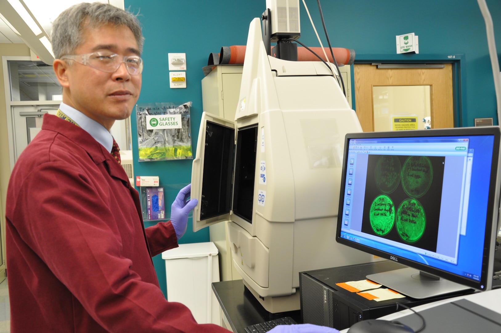 Navy scientist Yoon Hwang, Ph.D., Naval Medical Research Unit San Antonio’s Craniofacial Health and Restorative Medicine Directorate, checks the expression of visual markers for the development of genetically modified bacteriophages as a novel therapeutic strategy to treat periodontal infections. 