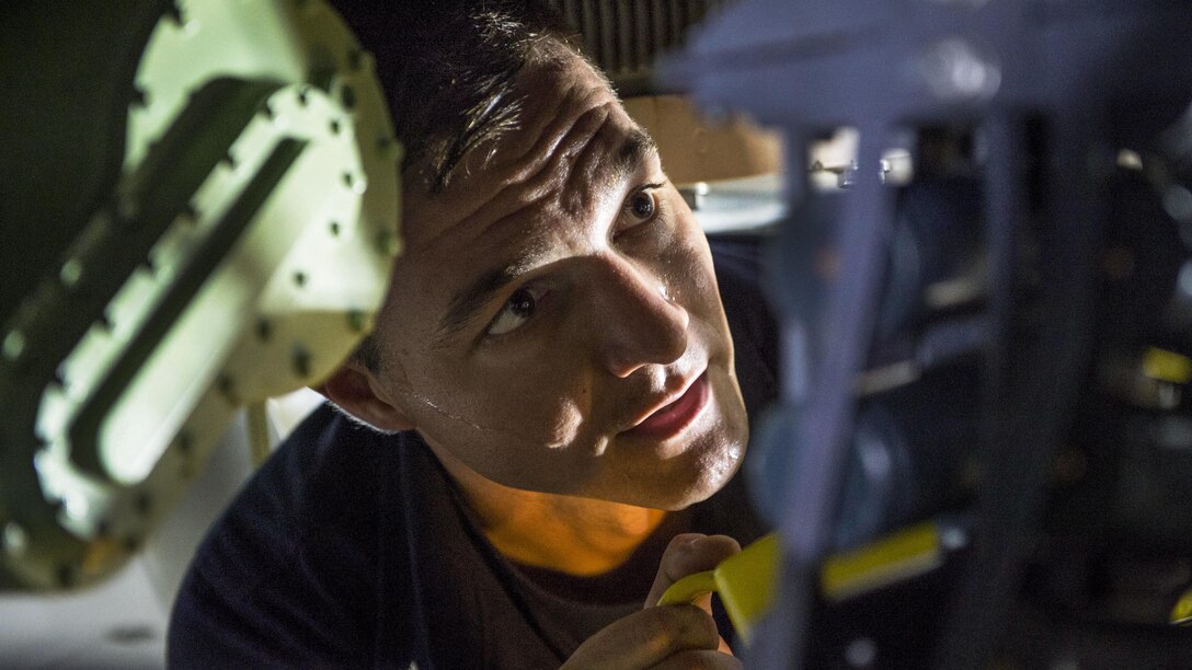 Navy Petty Officer 2nd Class Matthew Pruskauer works on an MK50 gun weapon system aboard the USS Coronado in the Singapore Strait, May 2, 2017. The littoral combat ship is on a rotational deployment in the U.S. 7th Fleet area of responsibility. Navy photo by Petty Officer 3rd Class Deven Leigh Ellis