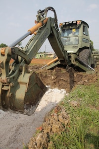 U.S. Army Sgt. Tyler Brady, with the 372nd Engineer Company, flattens gravel for the foundation of a new latrine at the St. Matthew's School as part of a broader school construction project for Beyond the Horizon 2017, St. Matthew's, Belize, May 1, 2017. Beyond the Horizon is a U.S. Southern Command-sponsored, Army South-led exercise designed to provide humanitarian and engineering services to communities in need, demonstrating U.S. support for Belize. (U.S. Army photo by Spc. Gary Silverman)