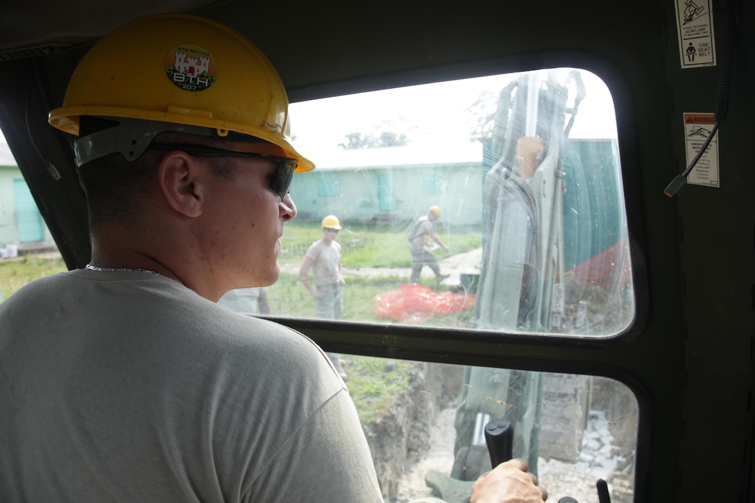 U.S. Army Sgt. Tyler Brady, with the 372nd Engineer Company, operates a backhoe to prepare the foundation of a new latrine at the St. Matthew's School as part of an additional school construction project during Beyond the Horizon 2017, St. Matthew's, Belize, May 1, 2017. Beyond the Horizon is a U.S. Southern Command-sponsored, Army South-led exercise designed to provide humanitarian and engineering services to communities in need, demonstrating U.S. support for Belize. (U.S. Army photo by Spc. Gary Silverman)