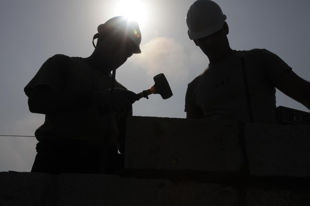 U.S. Soldiers, with the 372nd Engineer Company, make final adjustments to a cinder block wall at the St. Matthew's School construction site for Beyond the Horizon 2017, St. Matthew's, Belize, May 1, 2017. Beyond the Horizon is a U.S. Southern Command-sponsored, Army South-led exercise designed to provide humanitarian and engineering services to communities in need, demonstrating U.S. support for Belize. (U.S. Army photo by Spc. Gary Silverman)
