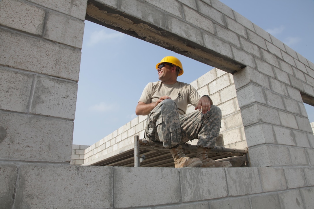 U.S. Army Spc. Matthew Medrow, with the 372nd Engineer Company, observes as the final cinder block is being put in place at the St. Matthew's School construction site during Beyond the Horizon 2017, St. Matthew's, Belize, May 1, 2017. Beyond the Horizon is a U.S. Southern Command-sponsored, Army South-led exercise designed to provide humanitarian and engineering services to communities in need, demonstrating U.S. support for Belize. (U.S. Army photo by Spc. Gary Silverman)