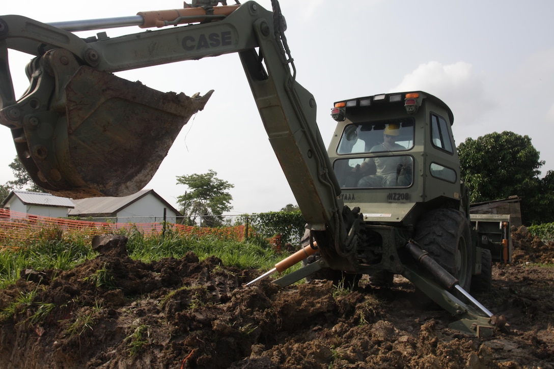 U.S. Army Sgt. Tyler Brady, with the 372nd Engineer Company, uses a backhoe to widen a ditch for the foundation of a new latrine at the St. Matthew's School as part of a broader school construction project for Beyond the Horizon 2017, St. Matthew's Belize, May 1, 2017. Beyond the Horizon is a U.S. Southern Command-sponsored, Army South-led exercise designed to provide humanitarian and engineering services to communities in need, demonstrating U.S. support for Belize. (U.S. Army photo by Spc. Gary Silverman)