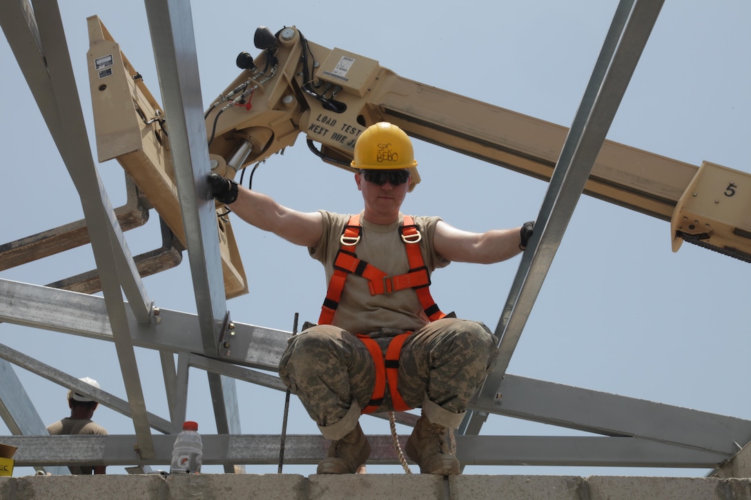 U.S. Army Spc. Chris Bebo, with the 372nd Engineer Company, prepares to position roof beams at the Ladyville, Belize Medical Clinic construction site, during Beyond the Horizon 2017, May 1, 2017. BTH 2017. Horizon is a U.S. Southern Command-sponsored, Army South-led exercise designed to provide humanitarian and engineering services to communities in need, demonstrating U.S. support for Belize. (U.S. Army photo by Spc. Gary Silverman)